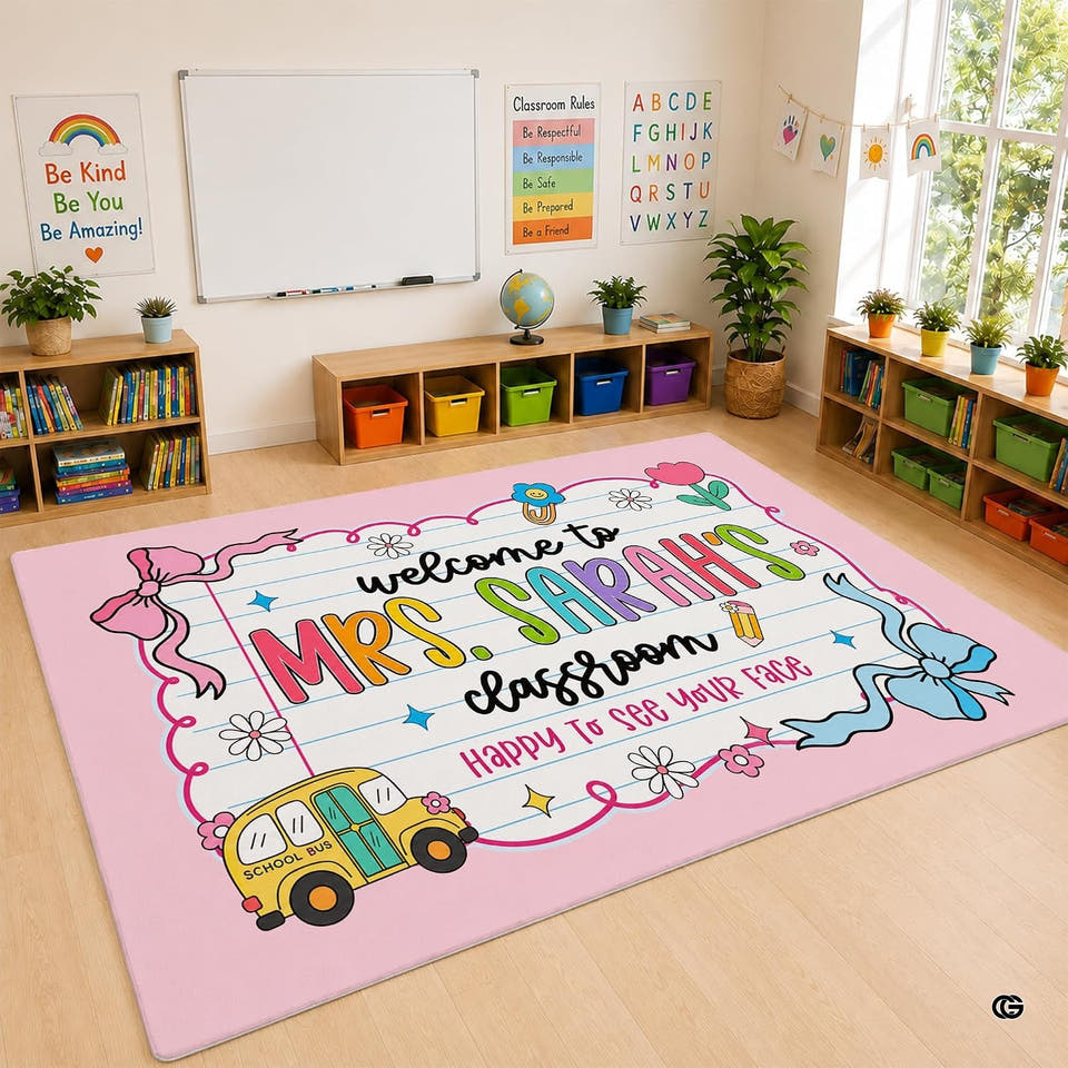 Pastel pink classroom area rug displaying lined paper motif, daisies, and decorative bow artwork across the floor.