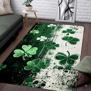 Top view of grunge clover area rug featuring emerald and cream split-tone backdrop with floating shamrocks. - thumbnail image 1 of 8
