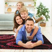 Dark crimson kraken octopus area rug styled in modern patio seating setup - thumbnail image 5 of 7