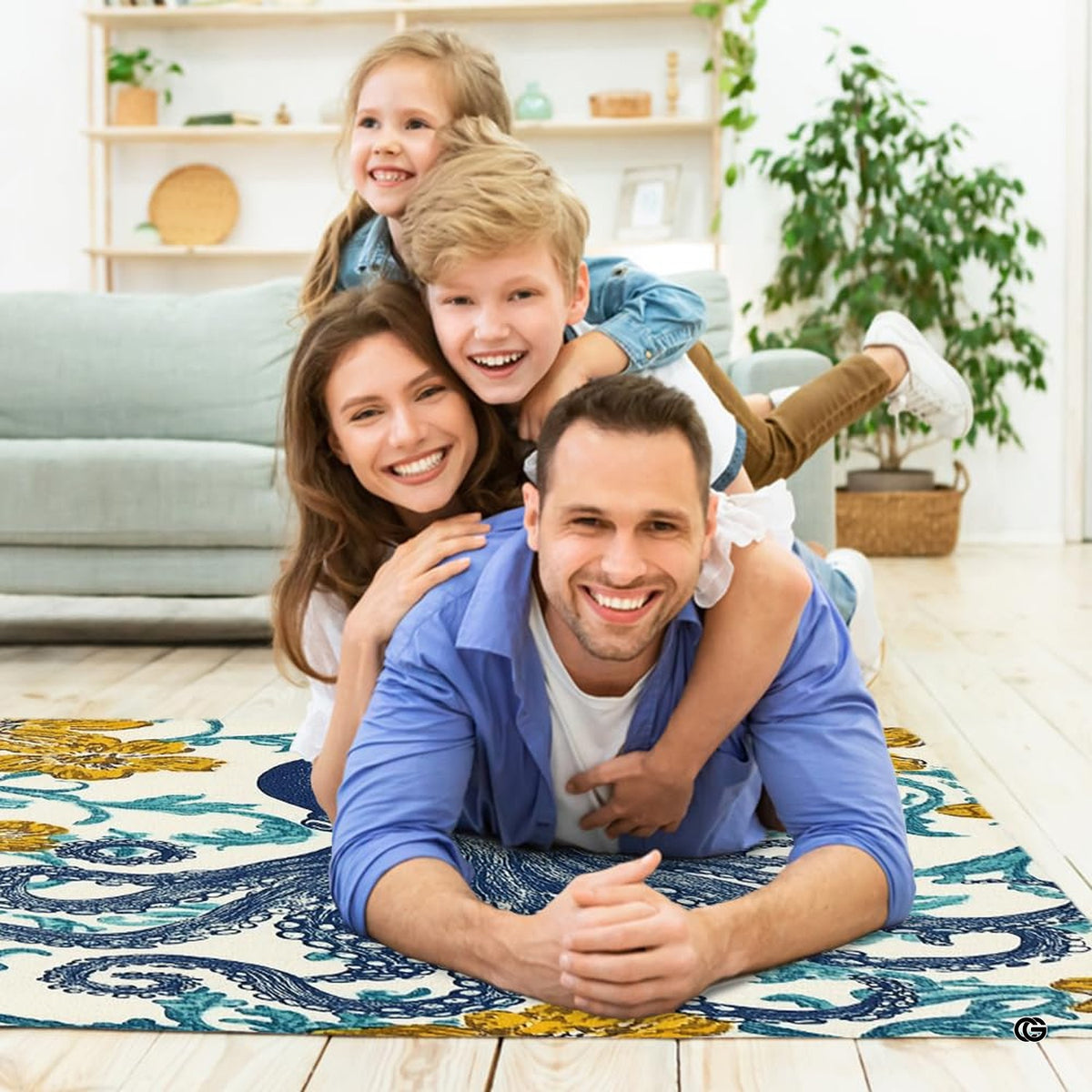 Lifestyle living room scene featuring family lounging on blue octopus floral area rug. - image 5 of 7