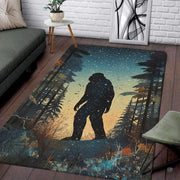 Silhouette area rug featuring Bigfoot walking in a pine forest under stars. - thumbnail image 1 of 5