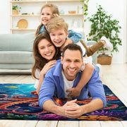 Lifestyle living room scene featuring family lounging on colorful octopus area rug. - thumbnail image 5 of 7