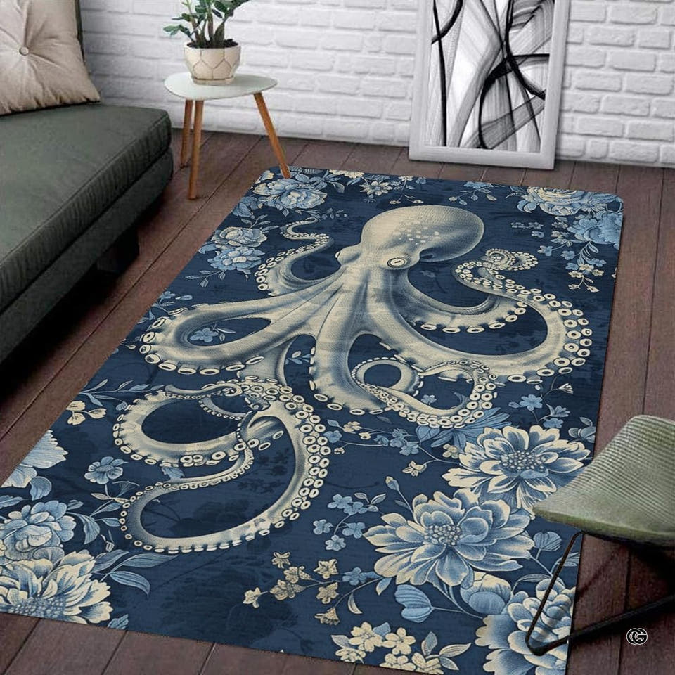 Rectangular floral octopus area rug in navy and ivory placed on dark wood flooring in a living room.
