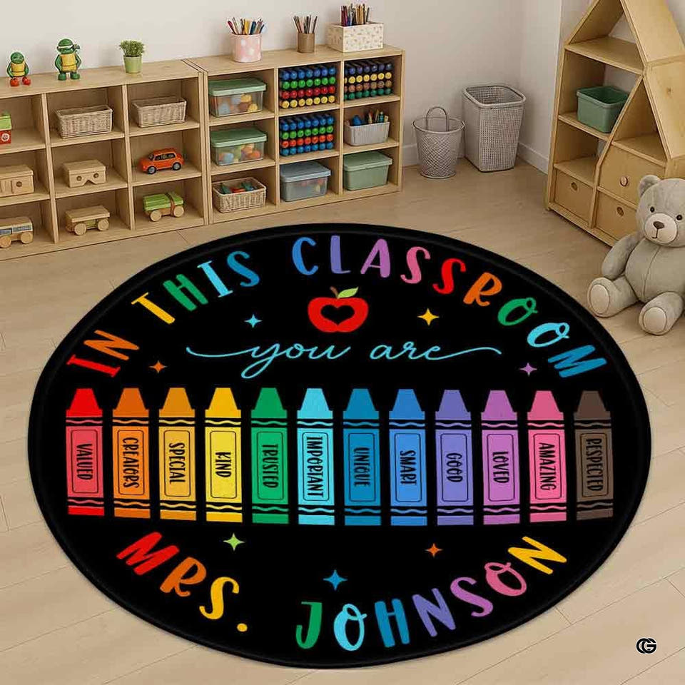 Classroom area rug with rainbow crayon motif and apple design on dark background.