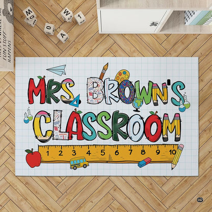 Close-up of school doodles area rug with yellow bus, beakers, and colorful patchwork letters. - thumbnail image 2 of 7