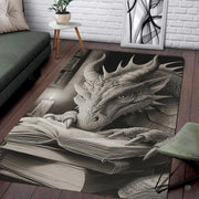 Charcoal fantasy dragon resting its head and claws on an open spellbook beside a candle in an ancient library area rug. - thumbnail image 7 of 8