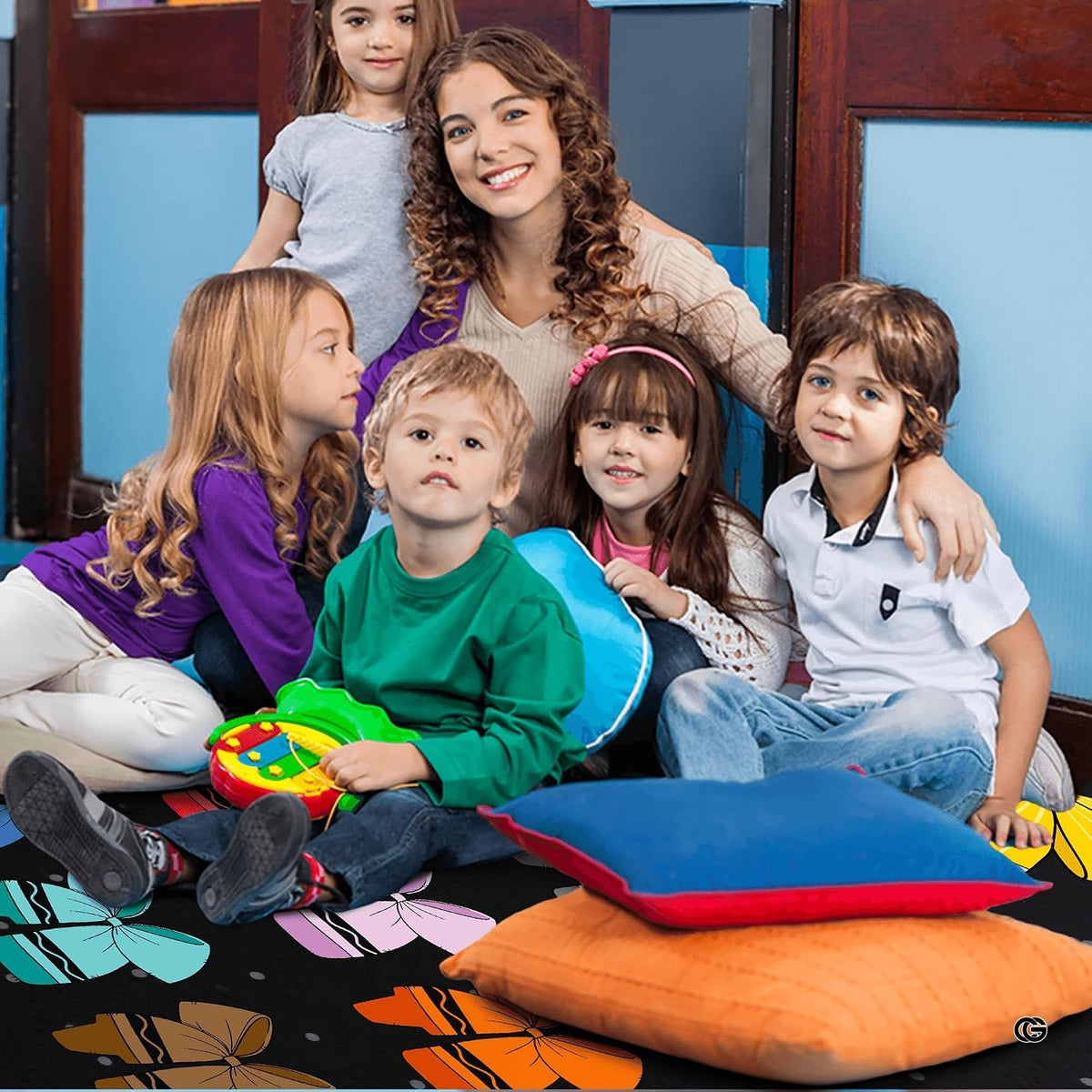 Close-up detail of crayon-shaped bows and polka dots on decorative classroom area rug.