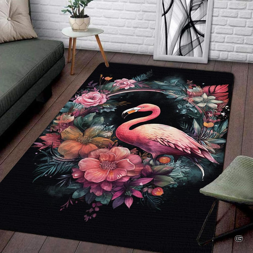 Rectangular area rug with pink flamingo inside botanical floral wreath on black ground