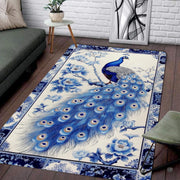 Blue peacock feather chinoiserie area rug featuring a regal bird and floral peony branches on an ivory ground. - thumbnail image 1 of 7