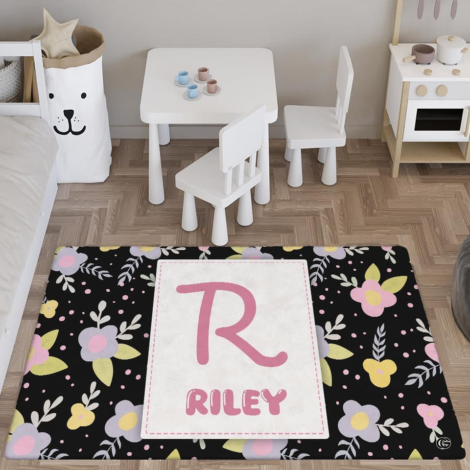 Black floral initial rug in a bright playroom