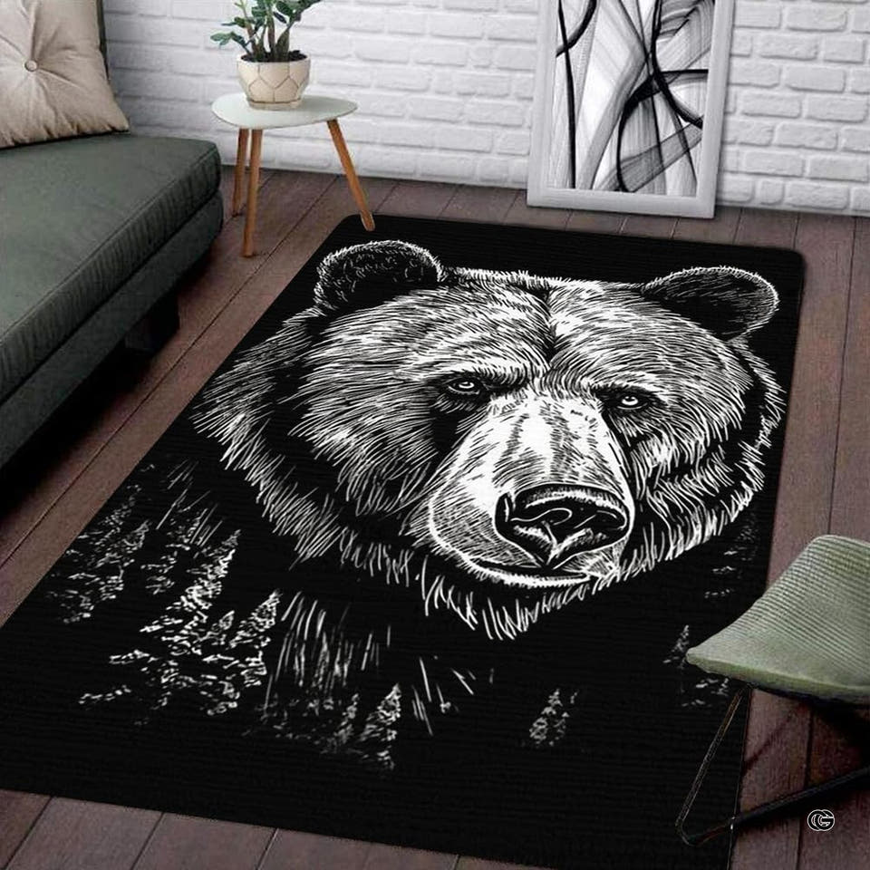 Grizzly bear forest portrait monochrome rectangular area rug displayed on dark wood floor beside a contemporary sofa.