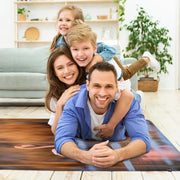 Overhead display of a vibrant pink flamingo floor rug over serene water scenery. - thumbnail image 6 of 7