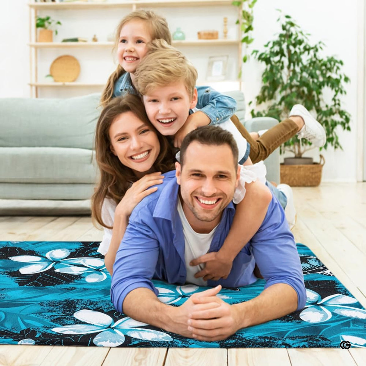 Lifestyle scene featuring family lounging on blue sea turtle area rug. - image 5 of 7