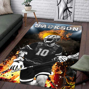 Patio stone lounge with wicker seating displaying the fiery lacrosse player area rug - thumbnail image 1 of 9