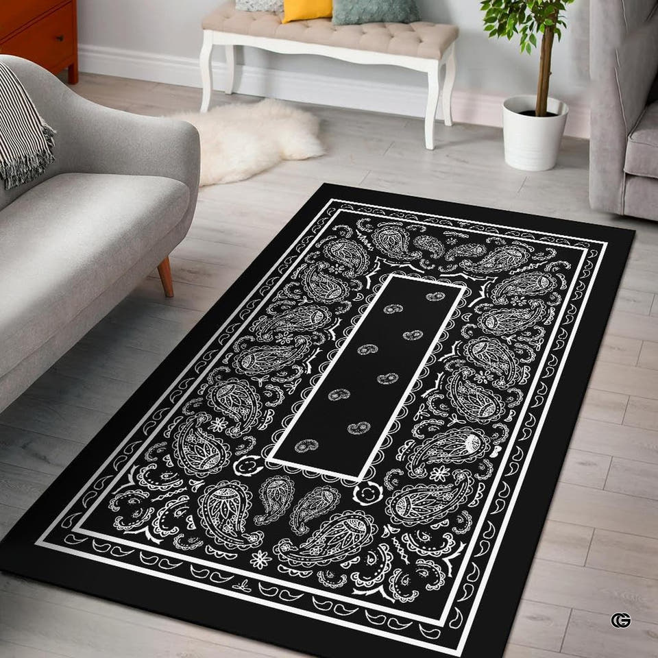 Black and white bandana paisley print area rug centered in a modern living space.