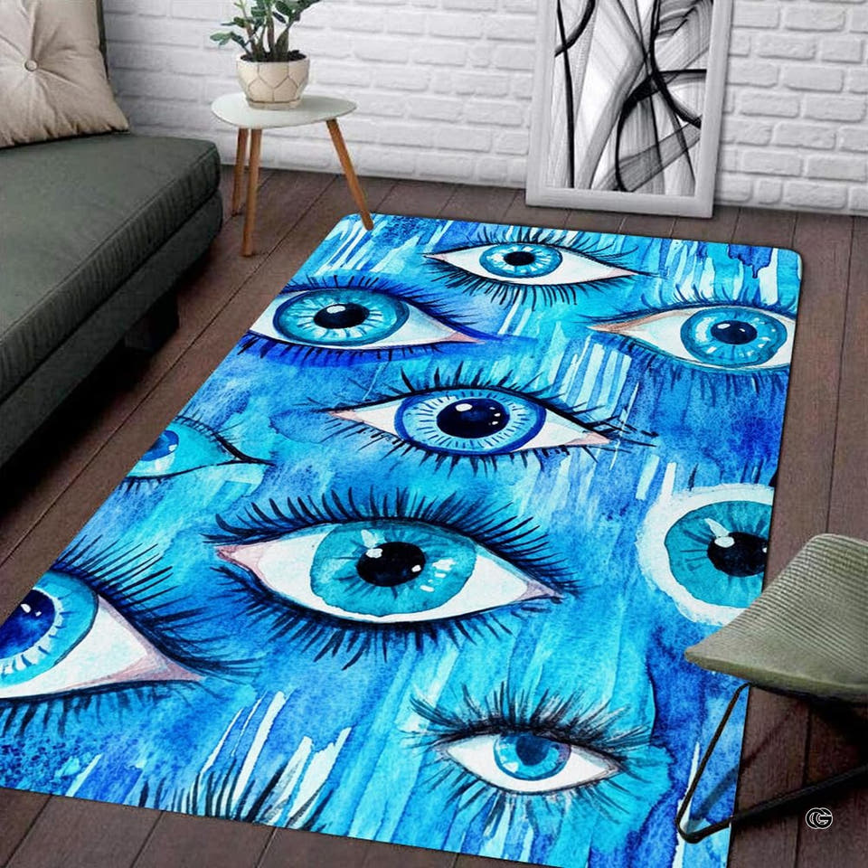 Living room setup with couch and white brick wall showcasing watercolor blue evil eyes area rug