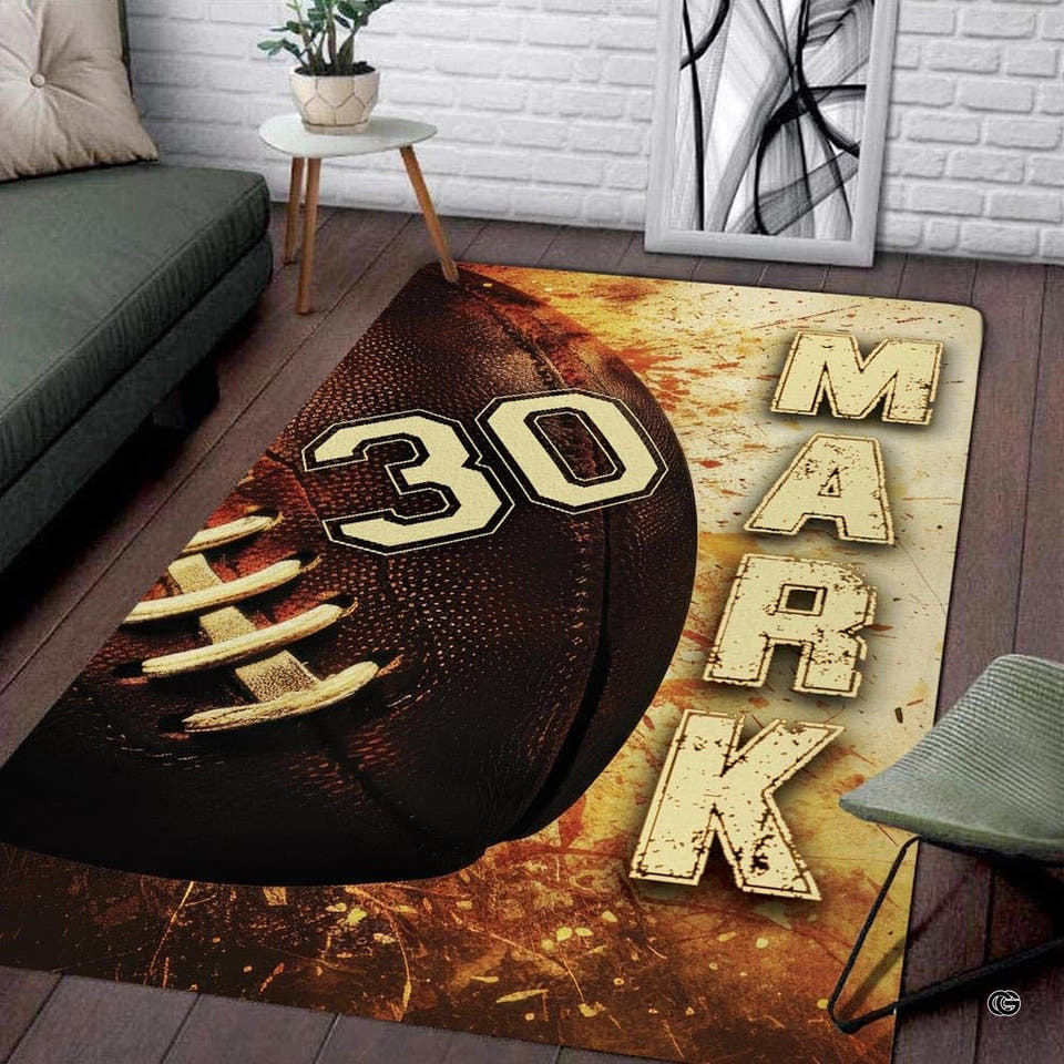 American football rectangular area rug with laces and grunge background displayed on living room wood flooring.