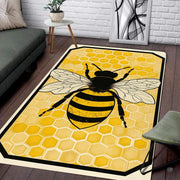 Overhead view of honey bee rug featuring black line art wings and amber geometric pattern. - thumbnail image 2 of 8