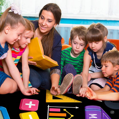 Lifestyle scene featuring teacher and students around math educational rug. - thumbnail image 5 of 7