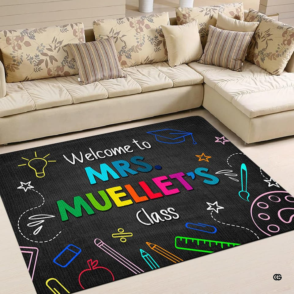 Chalkboard themed classroom area rug on light floor in front of a sectional sofa.