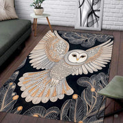 Close view of detailed line art, gold plumage accents, and stylized foliage on the barn owl rug. - thumbnail image 3 of 8