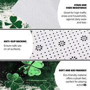 Angle view of black clover area rug displaying half emerald green and half cream splattered artistic backdrop. - thumbnail image 4 of 8