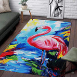 Living room setup with couch and white brick wall showcasing tropical pink flamingo area rug