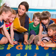 ASL alphabet area rug styled on hardwood flooring in classroom setting. - thumbnail image 4 of 9