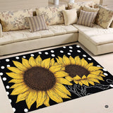 Vibrant sunflower floral floor rug featuring golden blossoms and polka dots on a solid black backdrop.