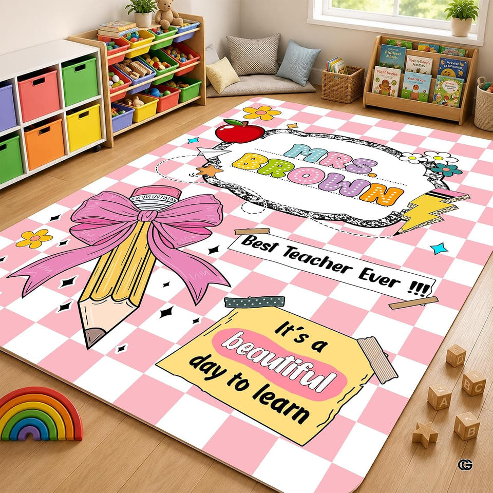 Pink checkered classroom area rug with yellow pencil and apple motifs in an elementary room.