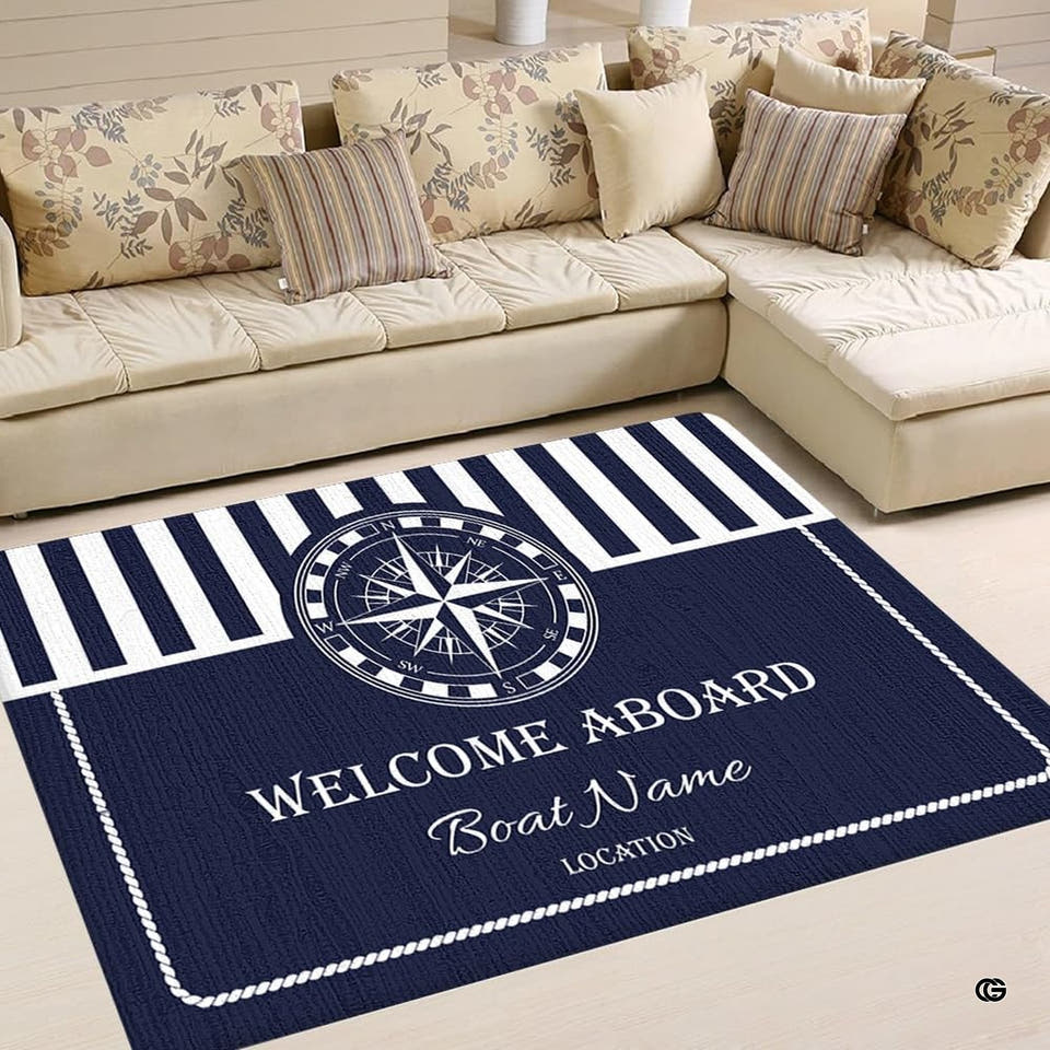 Nautical area rug with central compass rose medallion and navy blue stripes.