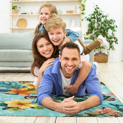 Lifestyle scene featuring family lounging on hibiscus sea turtle area rug. - thumbnail image 5 of 7