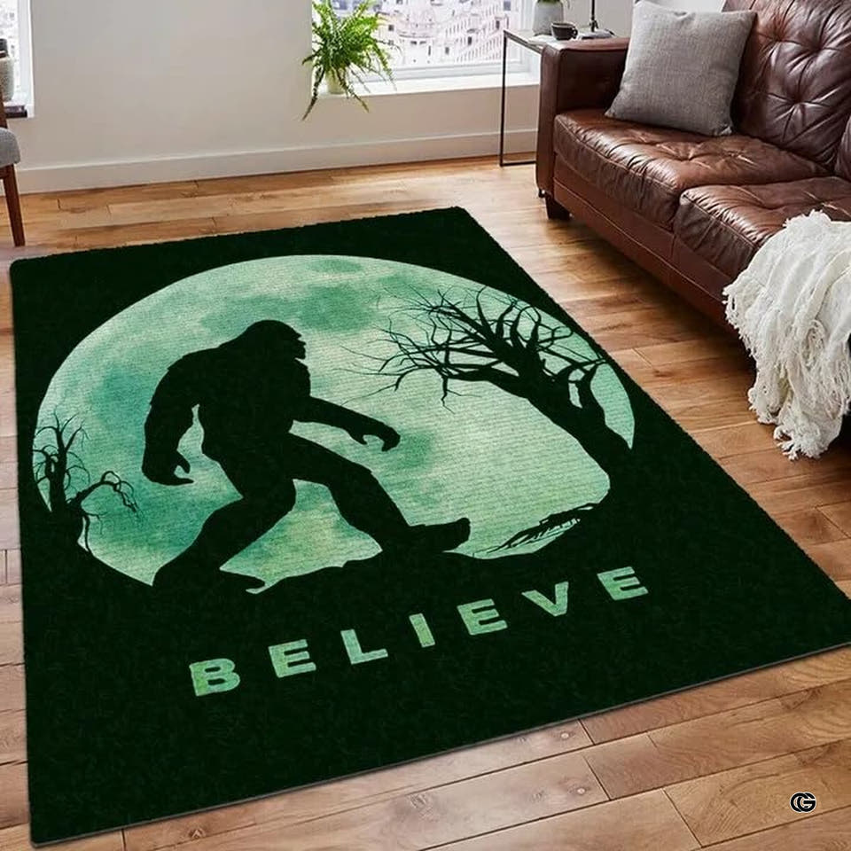 Bigfoot silhouette area rug showing Sasquatch striding across the ground before a bright full moon and trees.