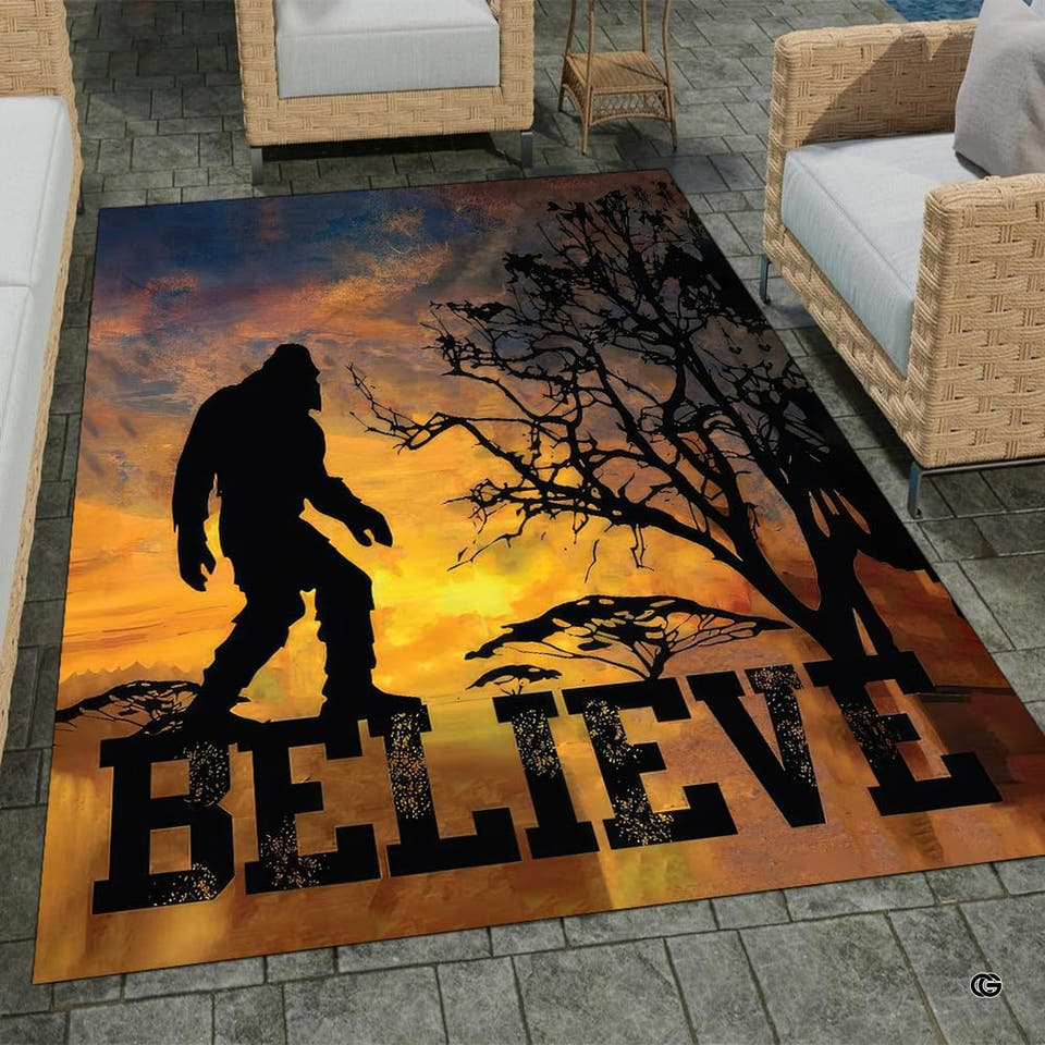 Outdoor patio setting showing the rectangular Bigfoot sunset wilderness area rug on stone tiles.