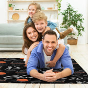Close-up perspective of basketball hoops, nets, and splatter graphics on a black sports theme area rug. - thumbnail image 5 of 7