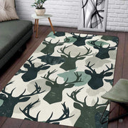 Green pattern area rug showcasing antlered buck silhouettes and watercolor camouflage patches in a living room. - thumbnail image 1 of 7