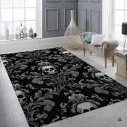 Fireside lounge setting with a person relaxing beside the gothic Victorian skull rug - thumbnail image 3 of 8