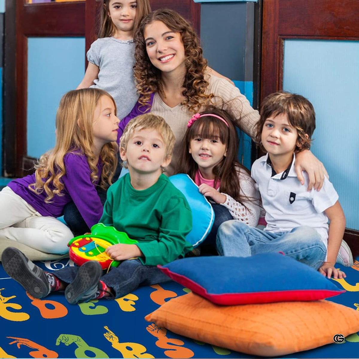 Lifestyle scene featuring teacher and students around educational classroom rug. - image 5 of 9