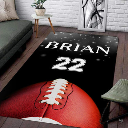 American football artwork area rug showing textured brown leather graphics and white stripes on dark background. - thumbnail image 1 of 7