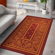 Burgundy maroon and gold yellow bandana paisley print living room area rug with ornate borders - thumbnail image 1 of 9