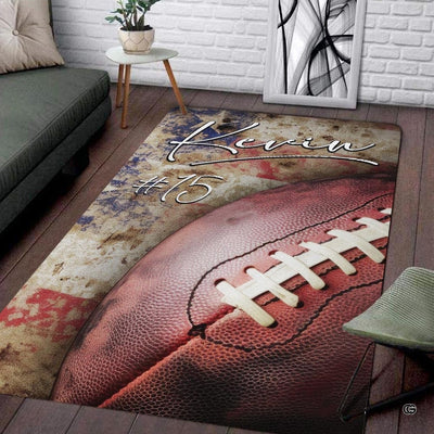 Vintage American football resting over a rustic distressed flag motif floor piece.