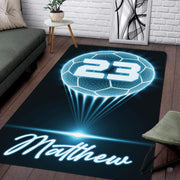 Modern living room floor setting featuring a neon glowing soccer ball athletic sports area rug - thumbnail image 1 of 7