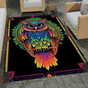Colorful mandala owl area rug with vivid rainbow plumage perched on a branch over a deep black background. - thumbnail image 1 of 8