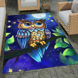 Full overhead view of whimsical owl area rug featuring glowing moon and starry indigo sky.