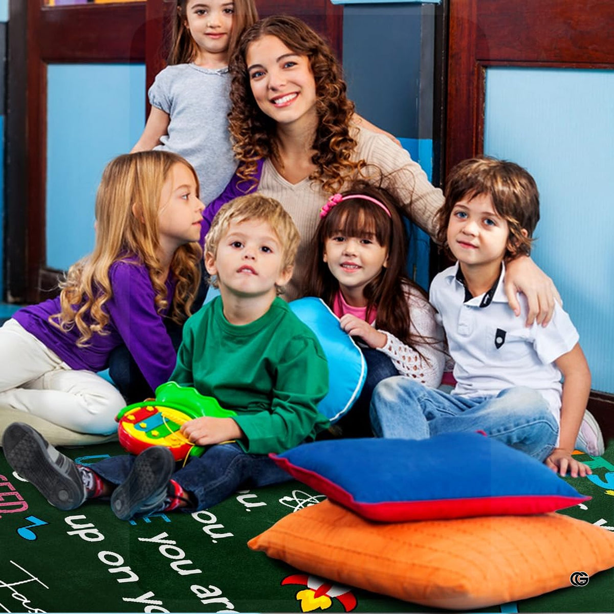 Close view of chalkboard texture, paper airplane art, and colorful educational doodles on rug.