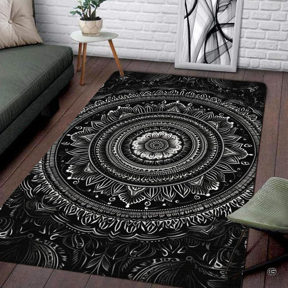 Black and white mandala lotus rectangular area rug displayed on wood flooring in a modern living room setting.