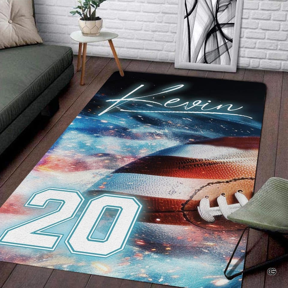 Cosmic American football rectangular area rug with glowing galaxy nebula displayed on dark living room flooring.