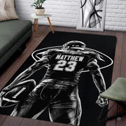 Living room floor setting featuring a monochrome football player sketch athletic area rug - thumbnail image 1 of 7