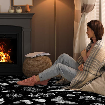 Fireside lounge setting with a person sitting on the gothic nature skull area rug - thumbnail image 3 of 8