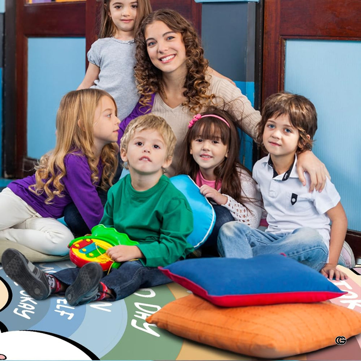 Teacher and smiling children gathered around cushions on the classroom rug - image 7 of 7